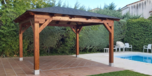 En la imagen se ve un porche de madera a cuatro aguas